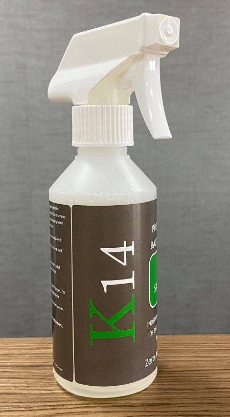 Bottle of K14 surface sanitising spray on a table