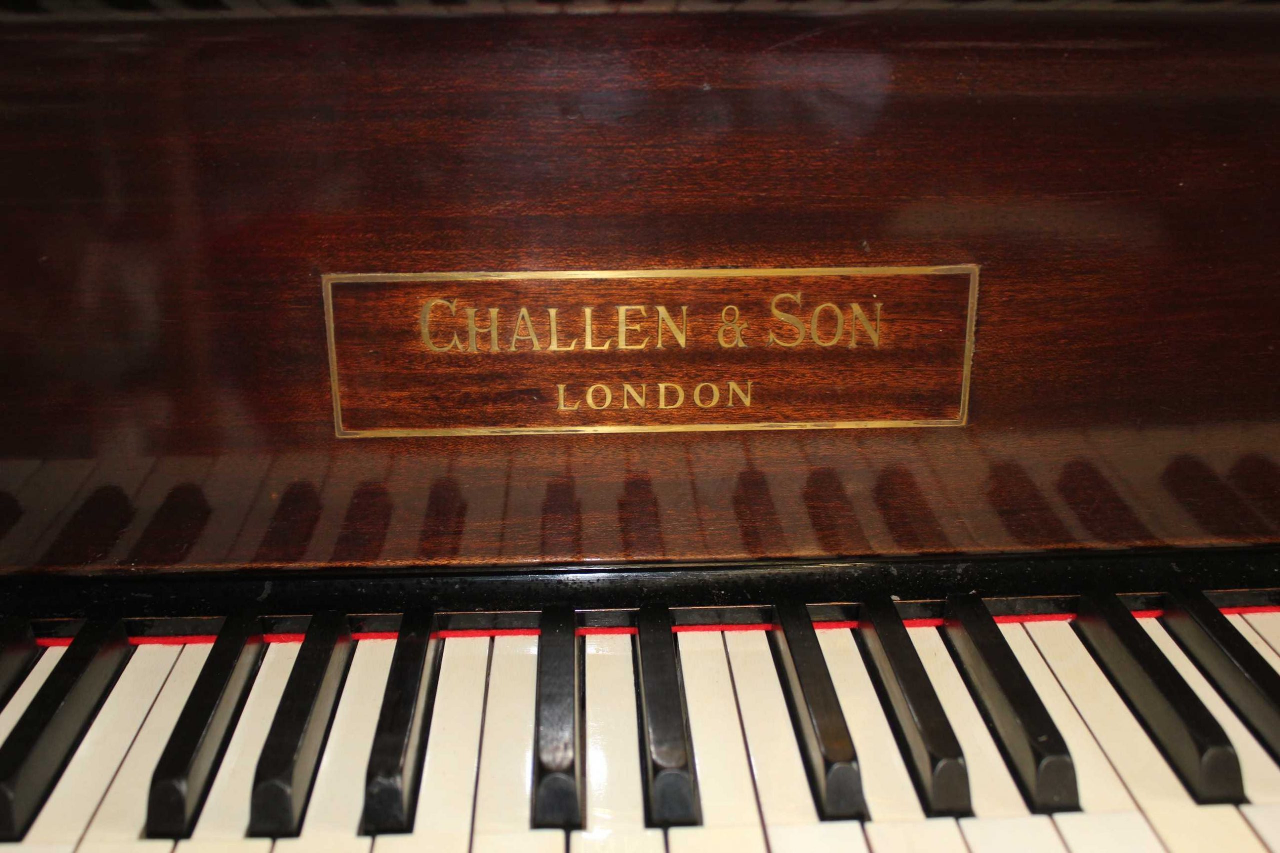 Challen antique baby grand piano close up of keys and lid nameplate